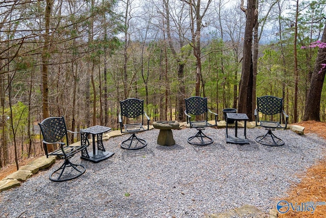 view of yard with a forest view and a patio area