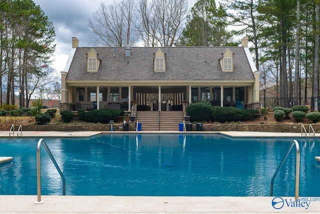 view of swimming pool with a fenced in pool and fence