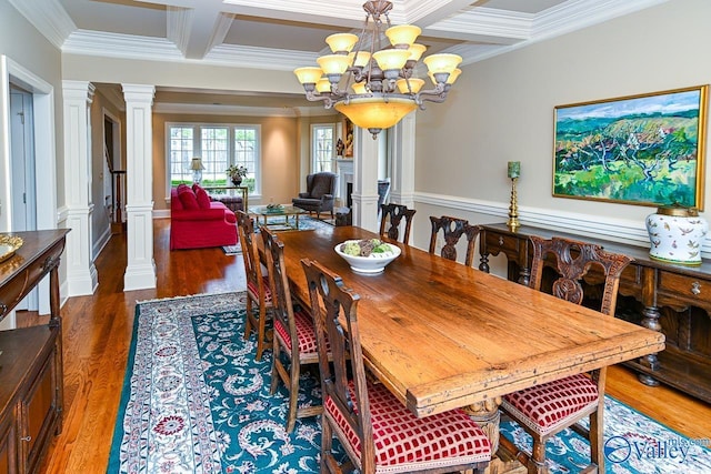 dining space featuring wood finished floors, decorative columns, beam ceiling, an inviting chandelier, and coffered ceiling