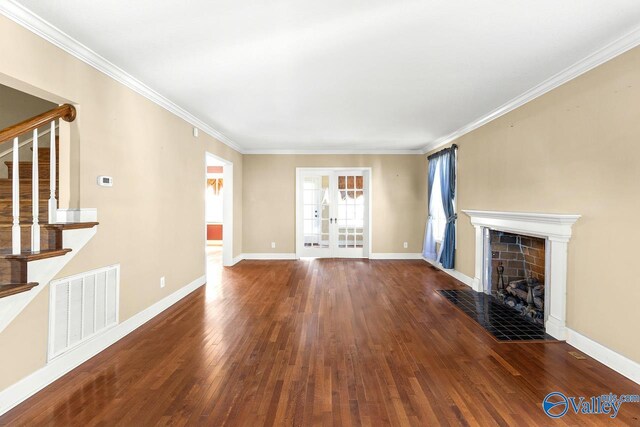 unfurnished living room with hardwood / wood-style floors, stairs, baseboards, and visible vents