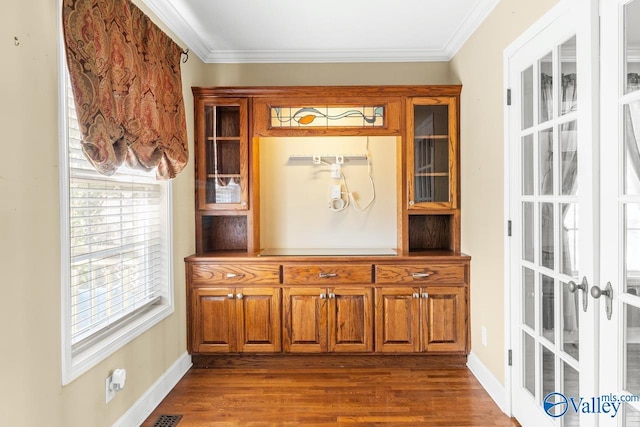 details featuring crown molding, wood finished floors, baseboards, and french doors