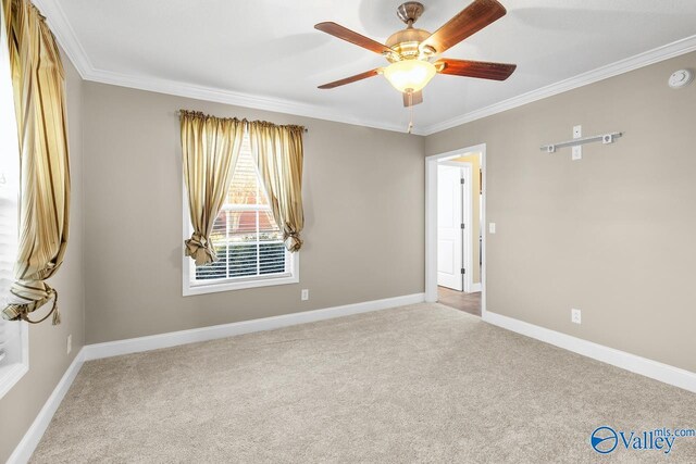 carpeted empty room featuring ceiling fan, baseboards, and ornamental molding