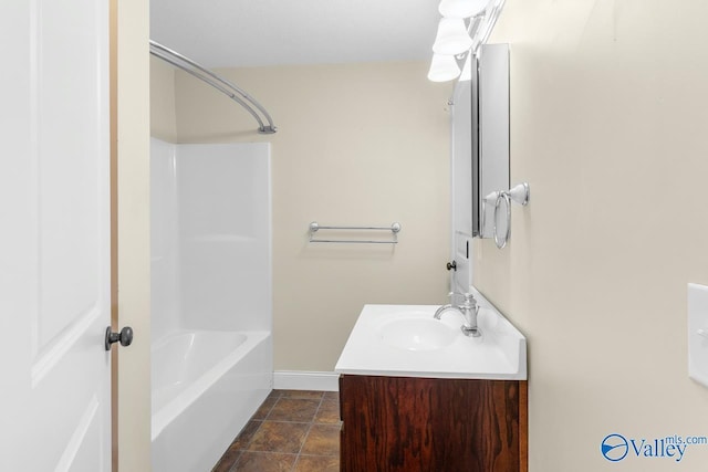 full bathroom with vanity, baseboards, and shower / bathtub combination