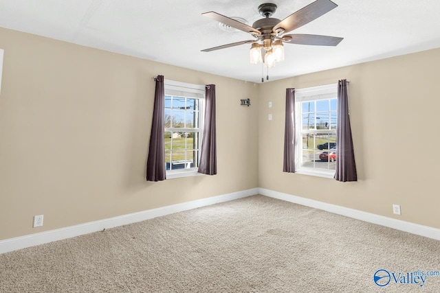 empty room with baseboards, carpet floors, and a ceiling fan