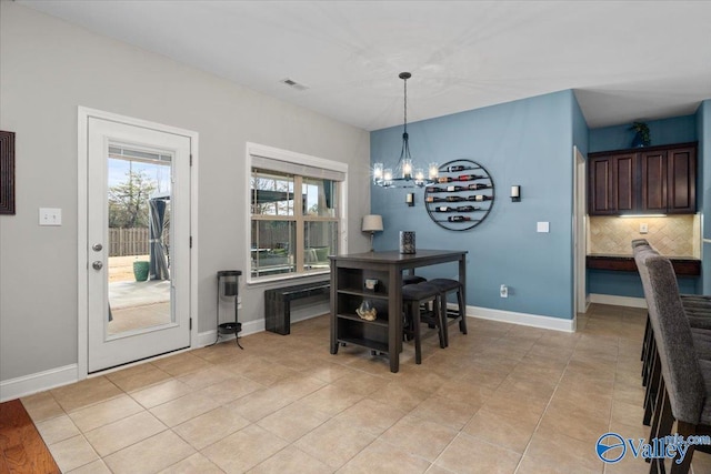 dining room featuring light tile patterned floors and a chandelier