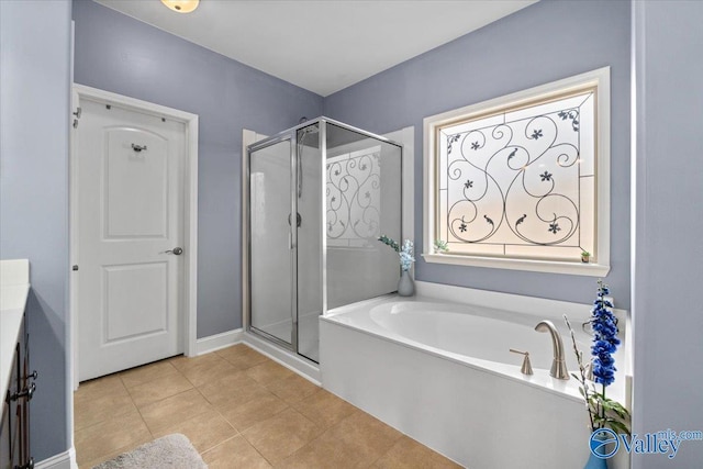 bathroom with tile patterned flooring, vanity, and separate shower and tub