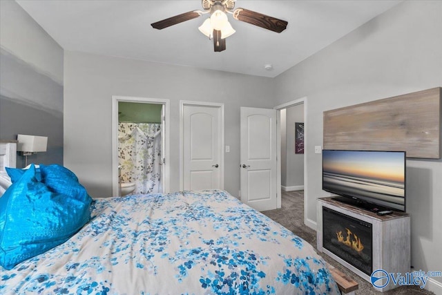 bedroom featuring ensuite bath, ceiling fan, and carpet