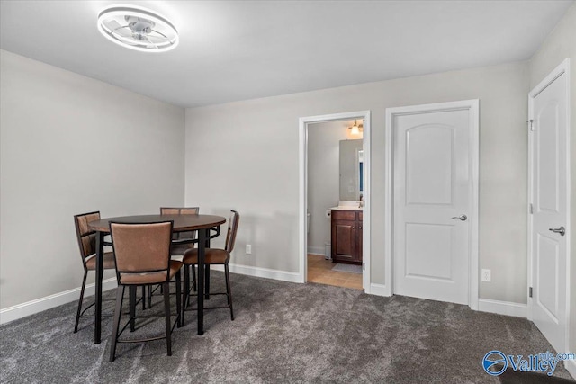 dining room featuring dark colored carpet