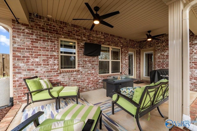 view of patio featuring grilling area, an outdoor living space with a fire pit, and ceiling fan