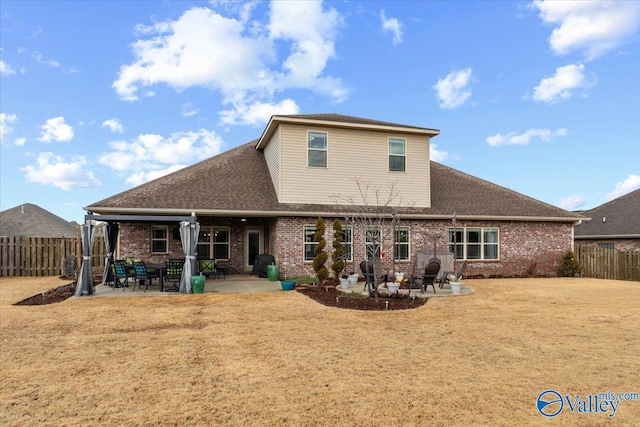 rear view of house featuring a yard and a patio area