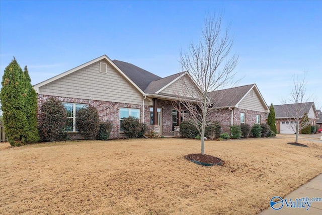 view of front of property with a garage and a front lawn