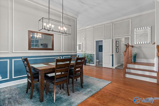 dining area featuring crown molding and wood-type flooring