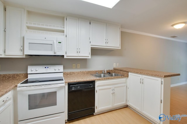 kitchen with ornamental molding, light wood finished floors, a sink, and white appliances