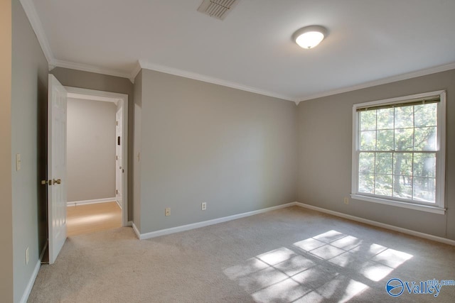 carpeted spare room with crown molding