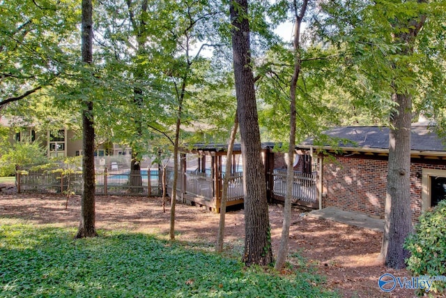 view of yard with a pool side deck