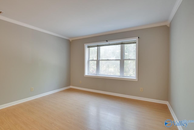 spare room featuring light hardwood / wood-style floors and ornamental molding