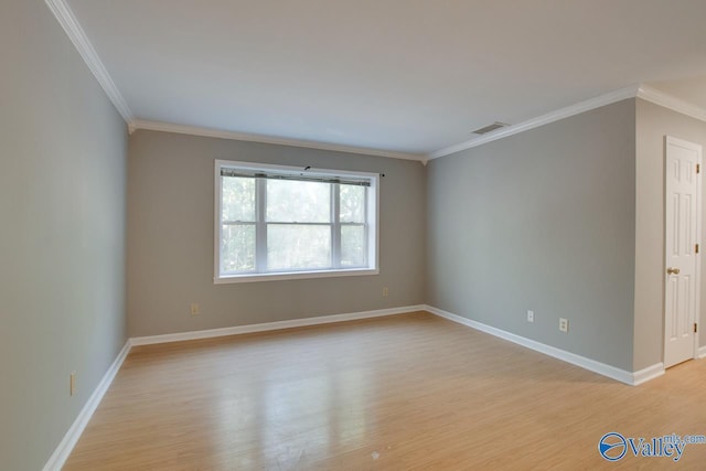 spare room with baseboards, crown molding, visible vents, and light wood-style flooring