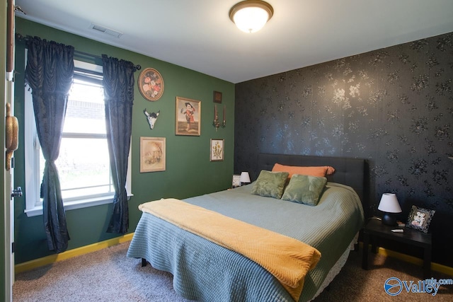 bedroom with wallpapered walls, carpet, visible vents, and baseboards