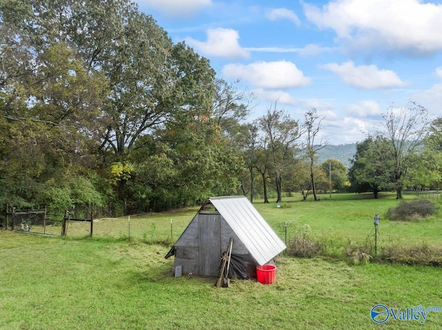 view of yard with fence and an outbuilding