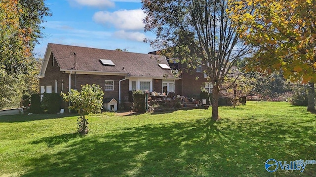 back of property with a patio and a yard