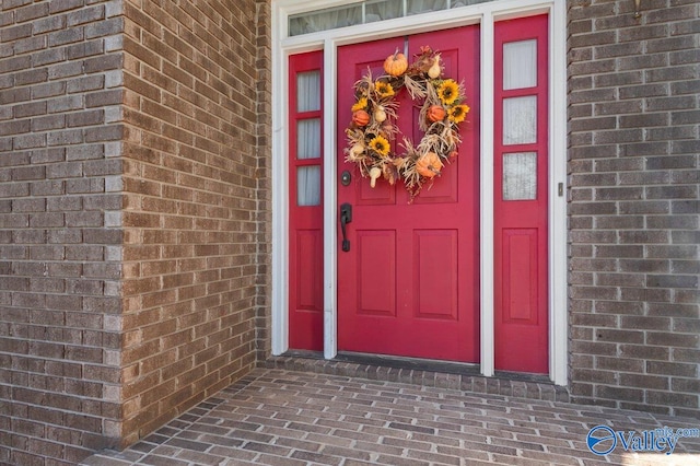 property entrance featuring brick siding