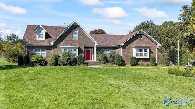 view of front facade featuring brick siding and a front lawn