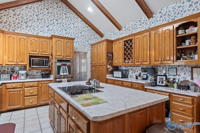 kitchen featuring decorative backsplash, an island with sink, lofted ceiling with beams, light tile patterned floors, and appliances with stainless steel finishes