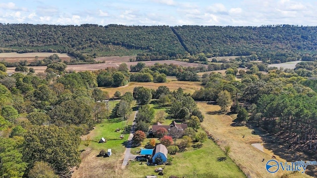 birds eye view of property with a view of trees