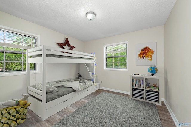 bedroom with hardwood / wood-style flooring and a textured ceiling