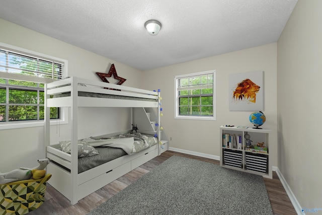 bedroom featuring dark hardwood / wood-style floors and a textured ceiling