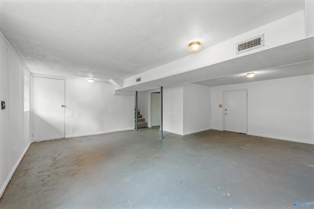 basement featuring a textured ceiling