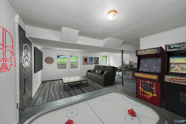 recreation room with concrete flooring and a textured ceiling