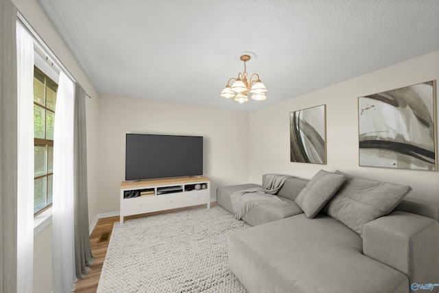 living room featuring wood-type flooring and a chandelier