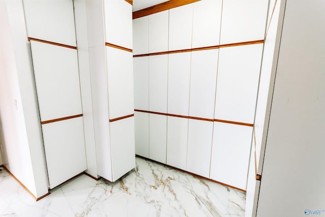 spacious closet with marble finish floor