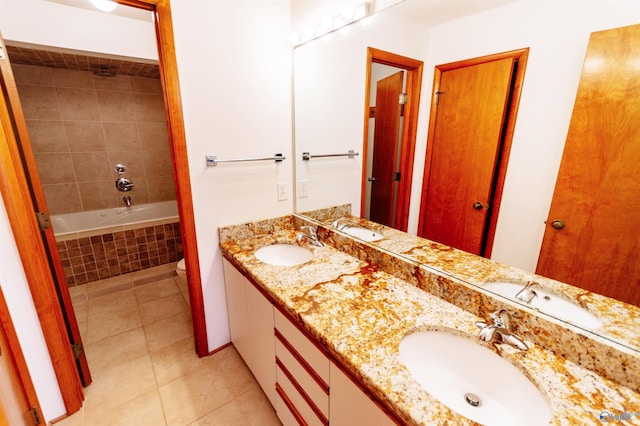 bathroom with tile patterned flooring, a sink, toilet, and double vanity