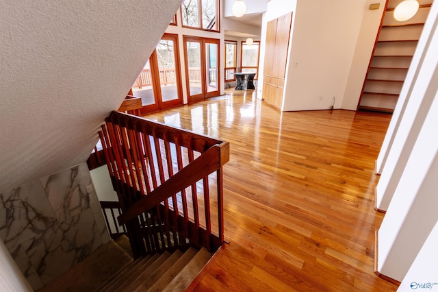 stairway featuring french doors and wood finished floors