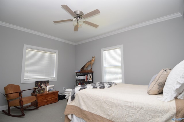 carpeted bedroom featuring ceiling fan and crown molding