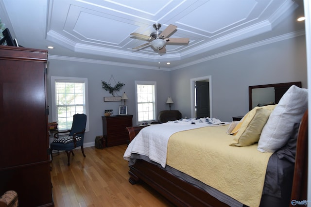 bedroom featuring multiple windows, ceiling fan, ornamental molding, and light wood-type flooring