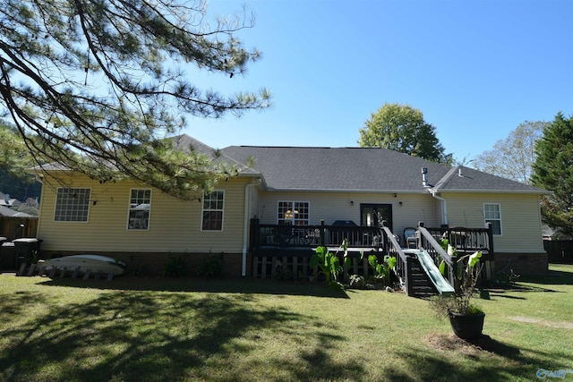 rear view of house featuring a yard and a deck