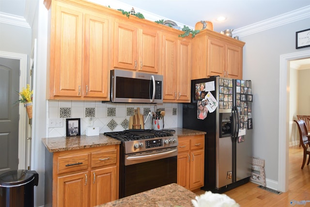 kitchen featuring appliances with stainless steel finishes, tasteful backsplash, crown molding, stone countertops, and light hardwood / wood-style floors