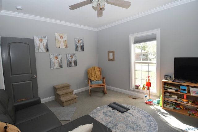 living area with carpet floors, ceiling fan, and ornamental molding