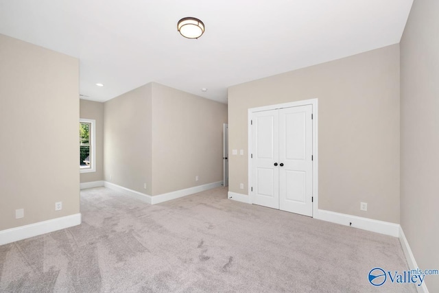 empty room with light colored carpet