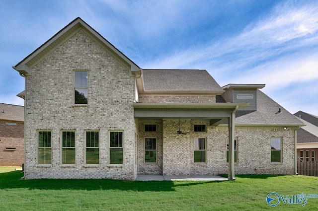 rear view of property with a patio and a lawn