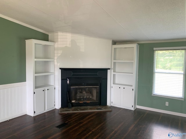 unfurnished living room featuring ornamental molding, dark hardwood / wood-style flooring, and a textured ceiling