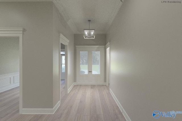 hallway with light wood finished floors, baseboards, ornamental molding, and a notable chandelier