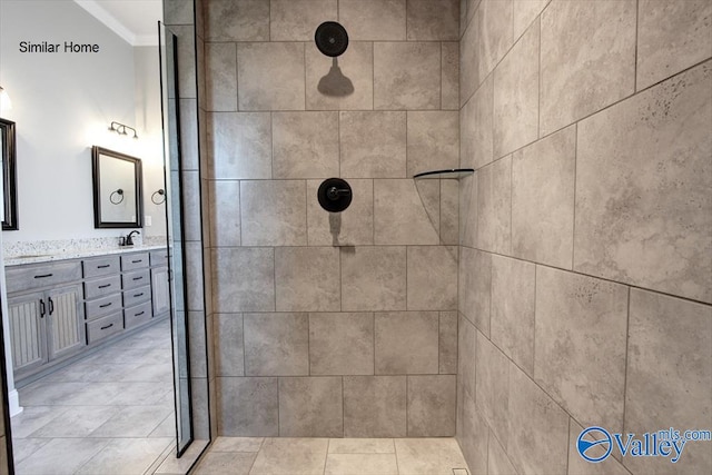 full bath featuring double vanity and tiled shower