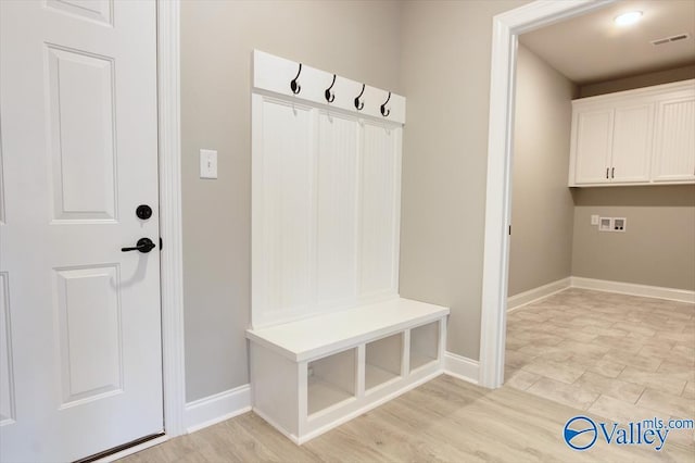 mudroom featuring visible vents, light wood finished floors, and baseboards