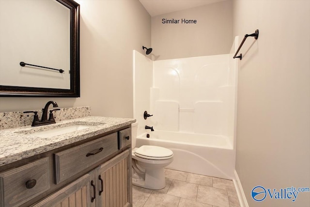 full bath featuring toilet, vanity, baseboards, tile patterned floors, and washtub / shower combination