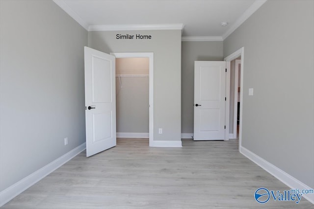 unfurnished bedroom with ornamental molding, a closet, light wood finished floors, and baseboards