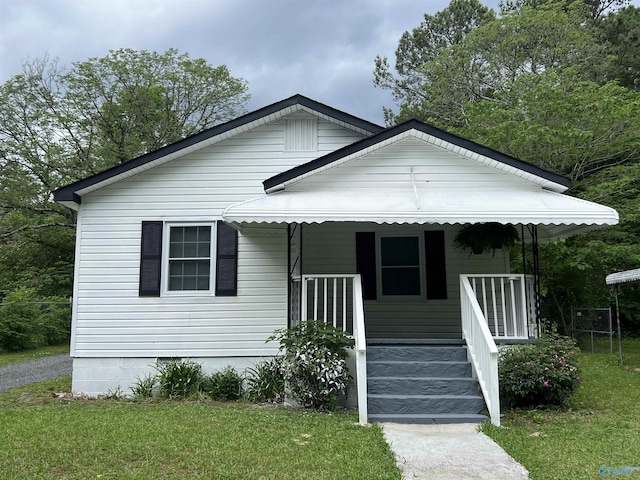 bungalow-style home featuring a porch and a front lawn